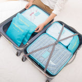 open view of packing suitcase with travel bags/clothing organizers