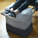 grey inflatable ottoman foot rest with person resting his/her feet